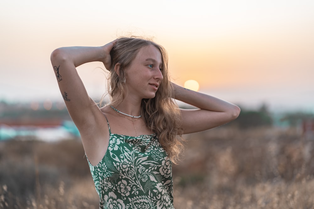 woman in green and white floral spaghetti strap top