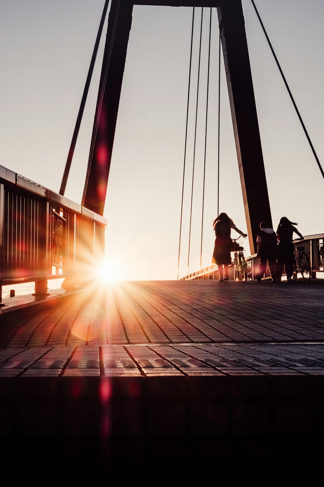 people sitting on wooden dock during sunset