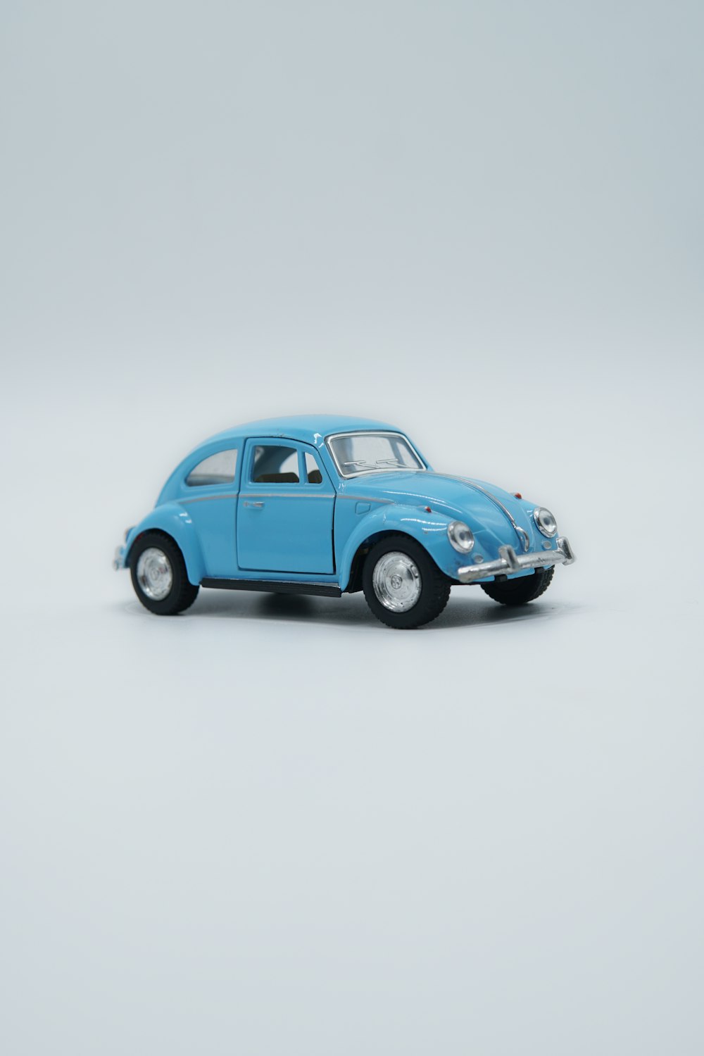 blue volkswagen beetle coupe on white background