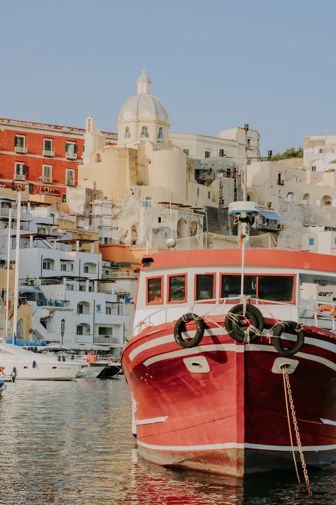 red and white boat on water near buildings during daytime