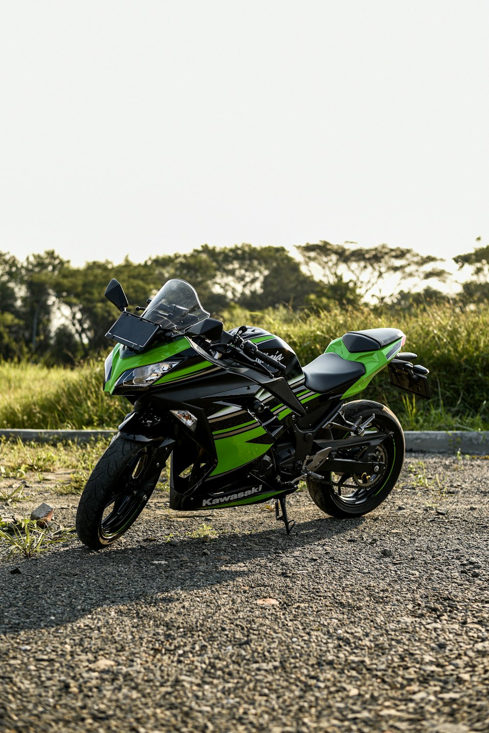 black and green sports bike on dirt road during daytime