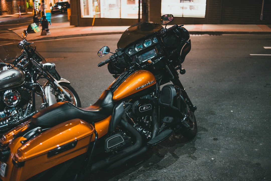 black and orange motorcycle parked on the side of the road