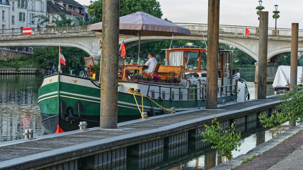 people riding on green and yellow boat on river during daytime