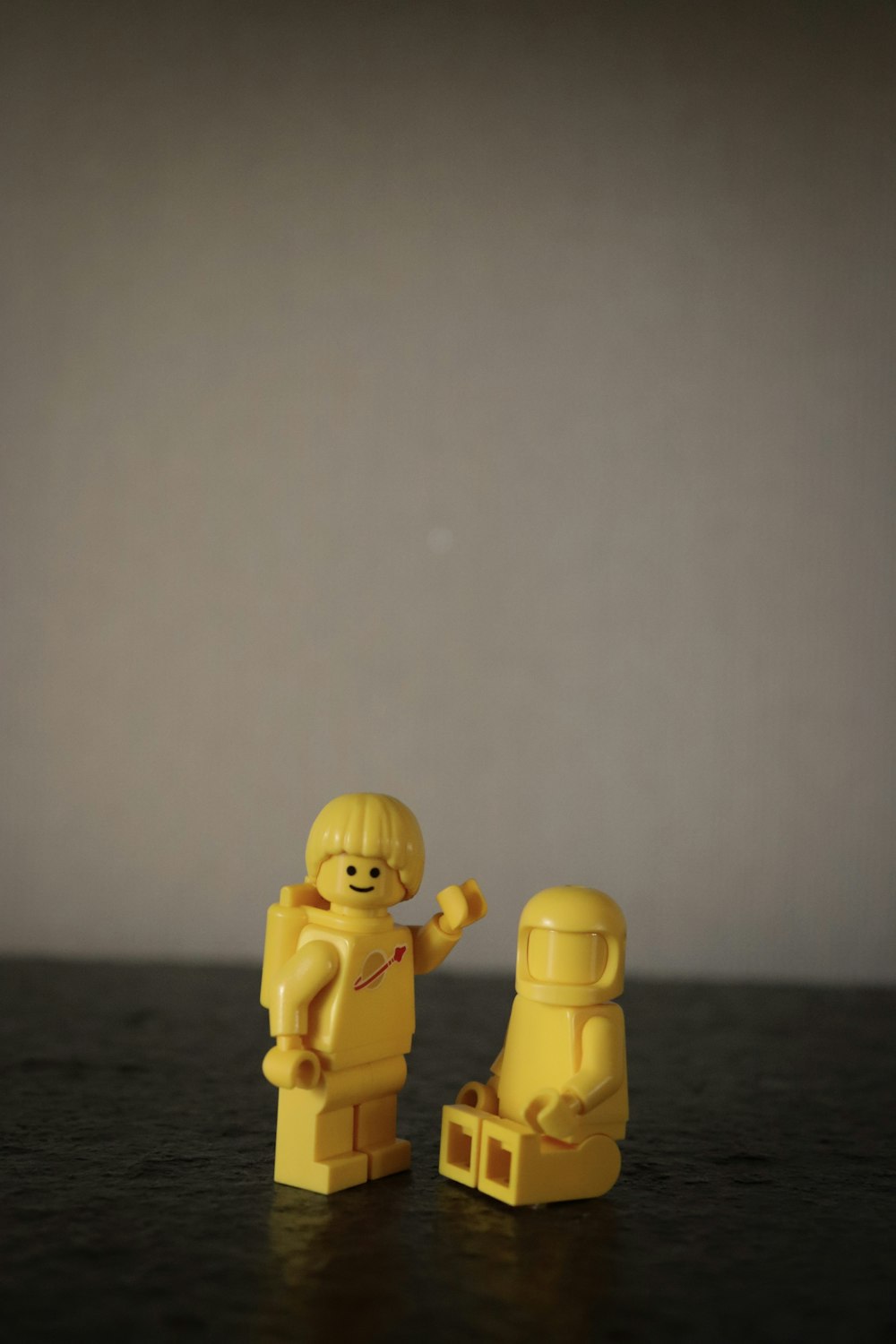 two gold human figures on black table