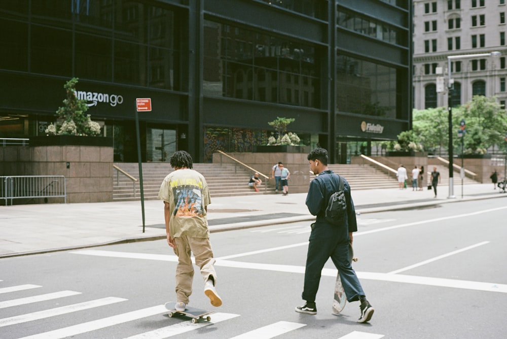 man in black jacket and yellow pants walking on pedestrian lane during daytime