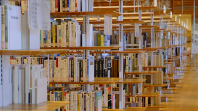 A peaceful moment in the madrasah library with shelves full of books in multiple languages