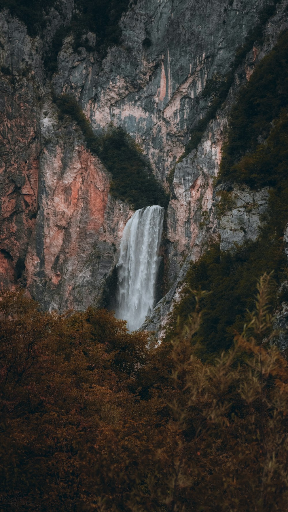 waterfalls in brown rocky mountain during daytime