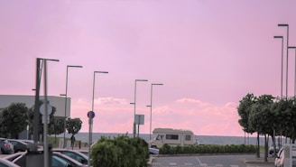 A secure parking lot near the sunny Arenales del Sol beach with caravans and boats parked.