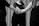 grayscale photo of man and woman holding hands