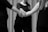 grayscale photo of man and woman holding hands