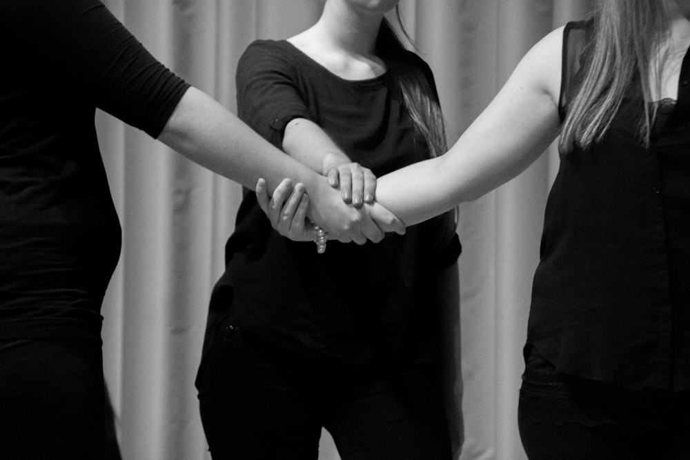 grayscale photo of man and woman holding hands