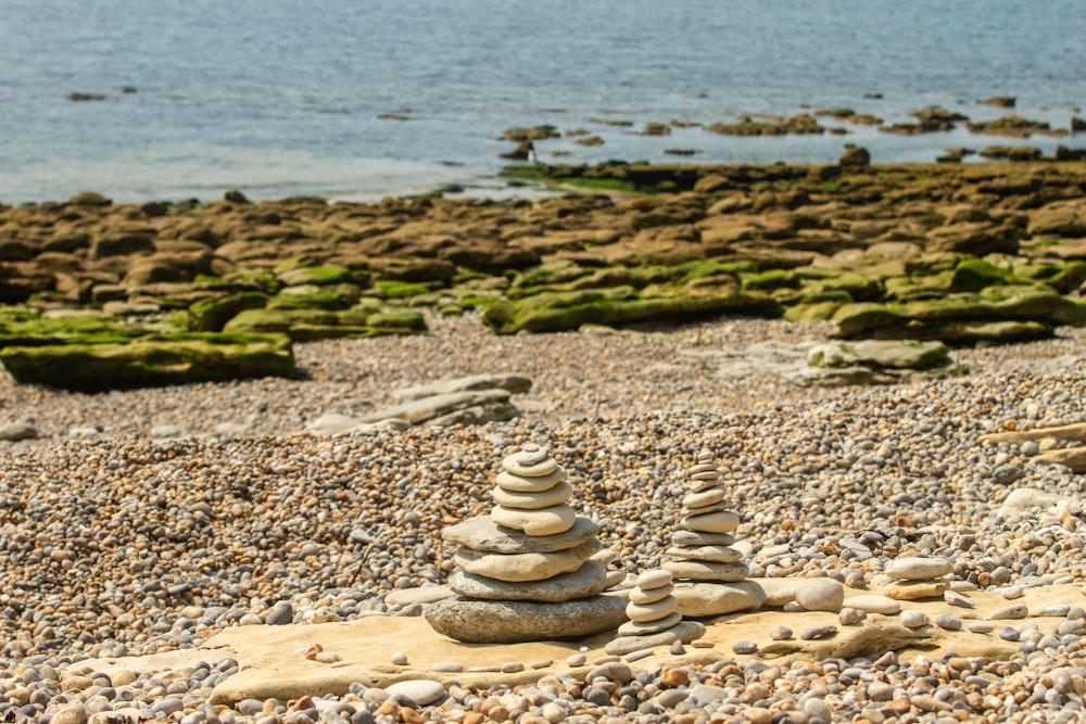 stack of stones on seashore during daytime