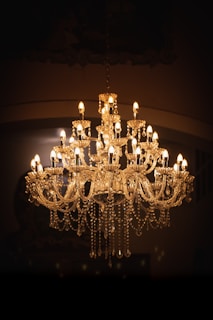 brass uplight chandelier turned on in room