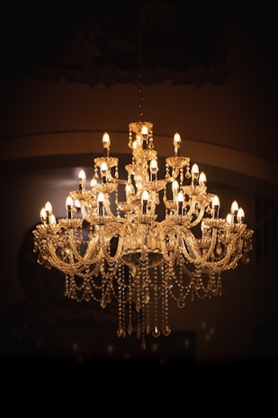 brass uplight chandelier turned on in room