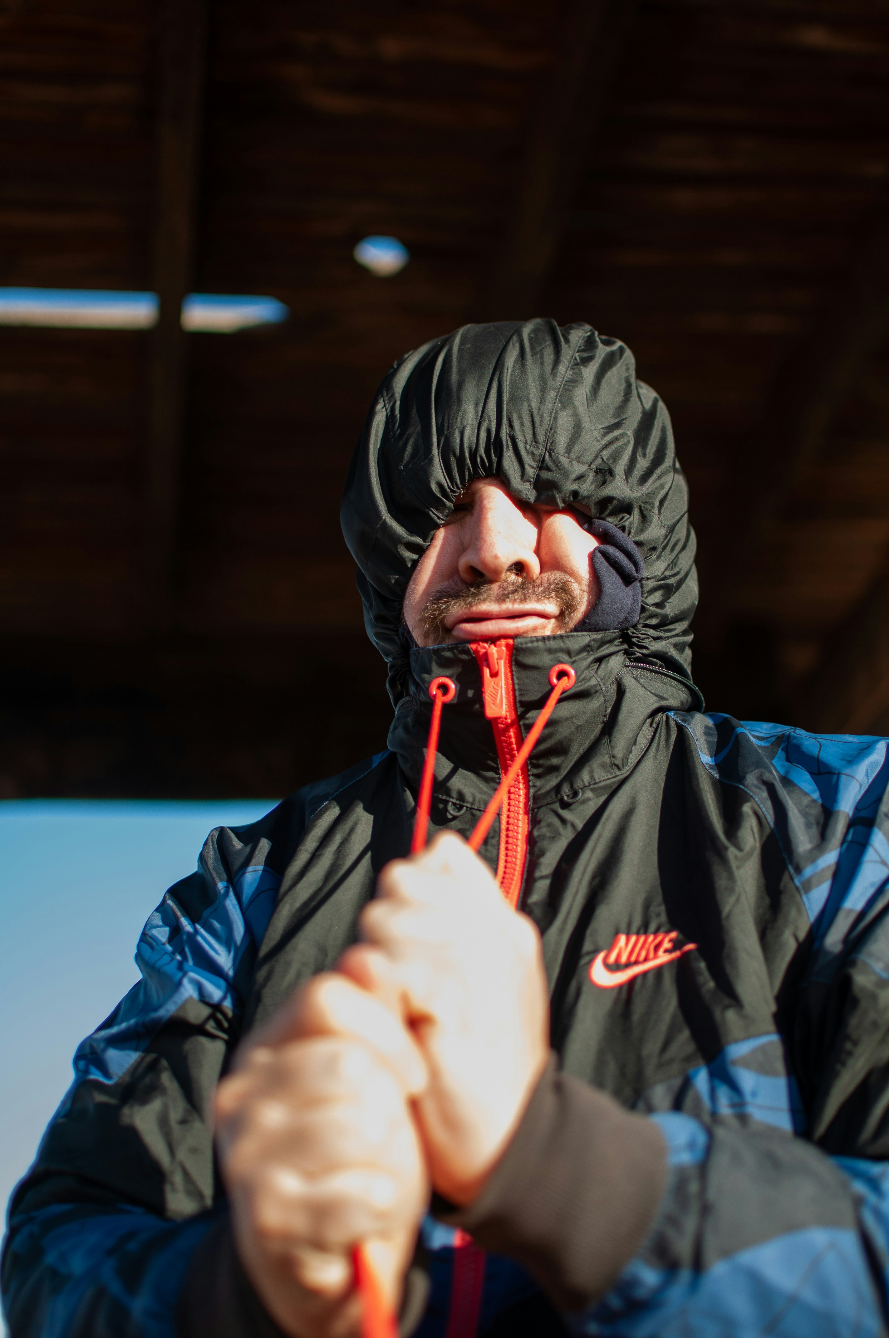 person in black jacket wearing orange goggles