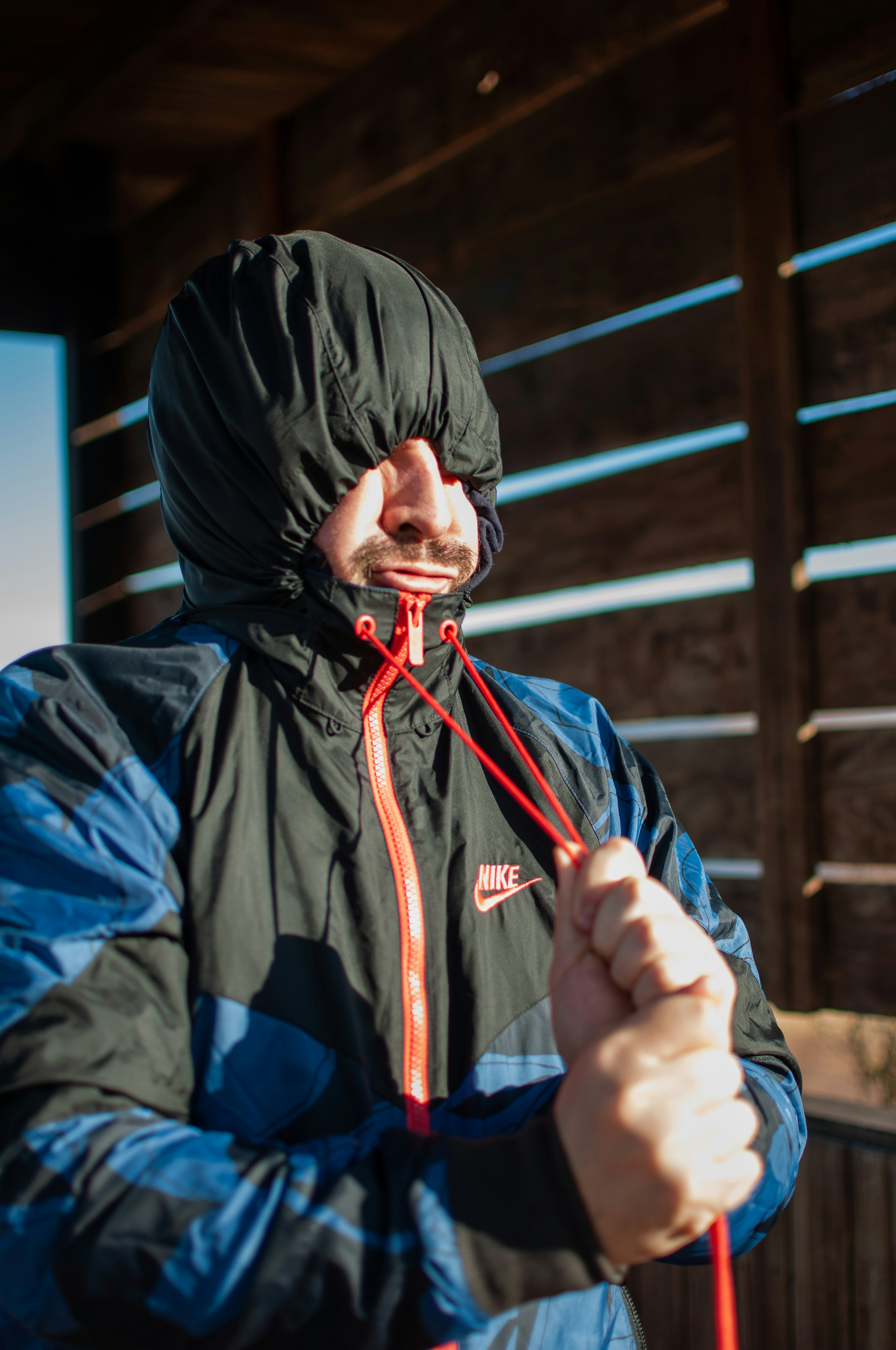 person in black jacket wearing black knit cap