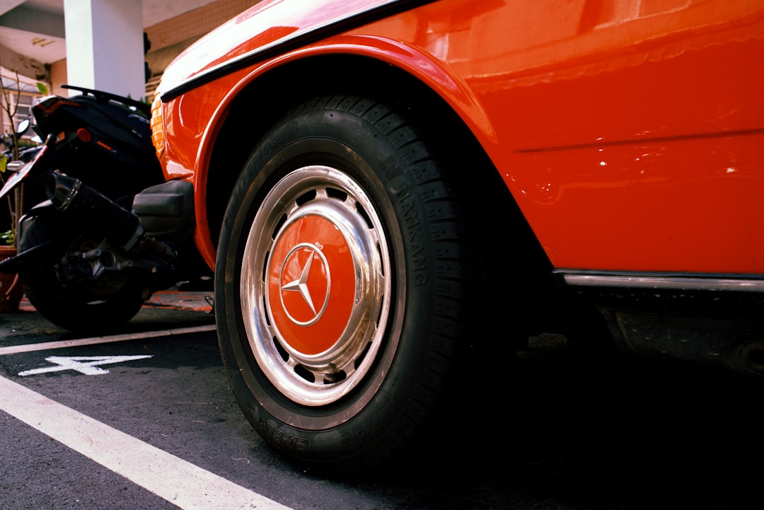 orange and silver car on road