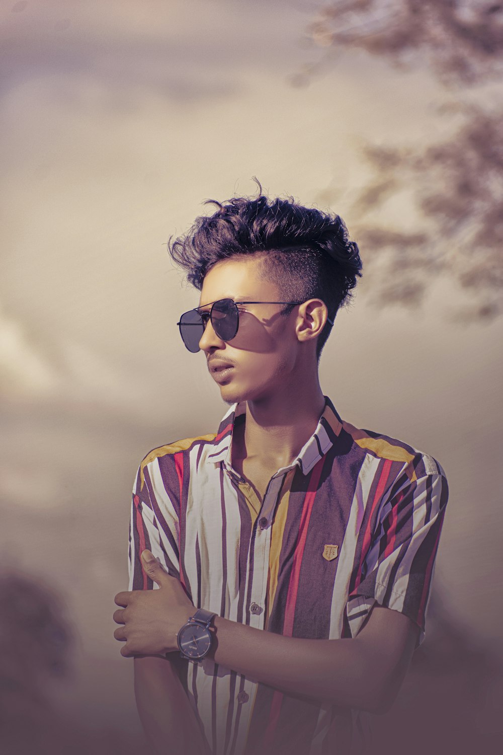 man in white and red plaid button up shirt wearing black sunglasses