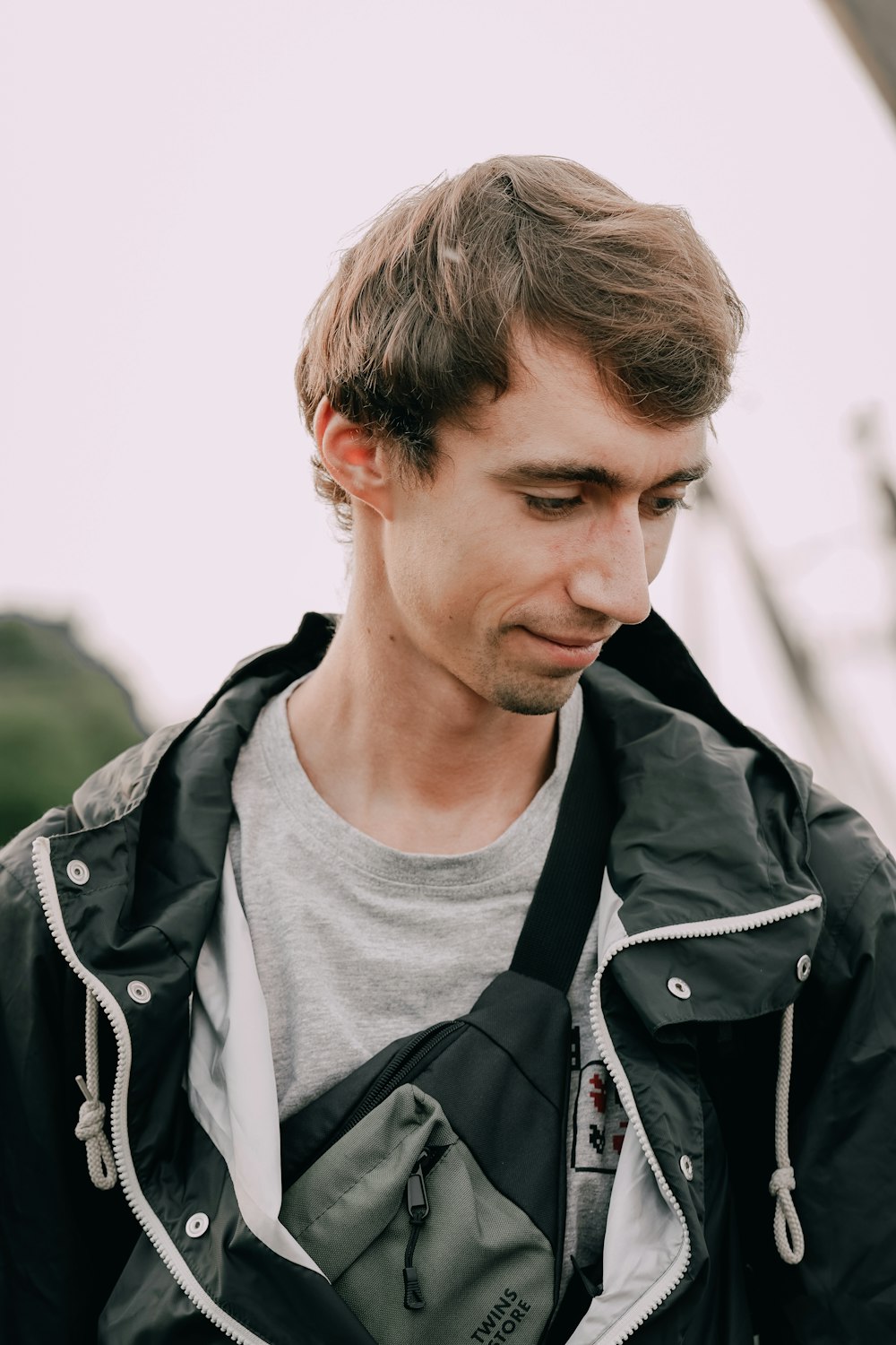 man in black jacket and gray crew neck shirt