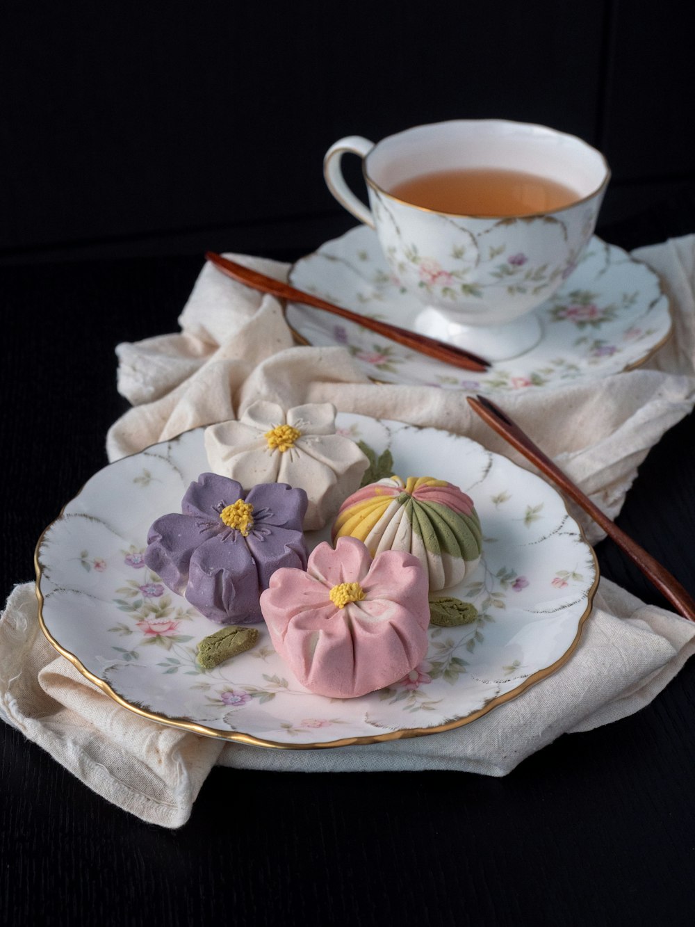 white and pink floral ceramic teacup on white floral ceramic saucer