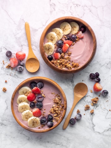 Brazilian açaí bowl, with latin american bananas, strawberries, blueberries and granola