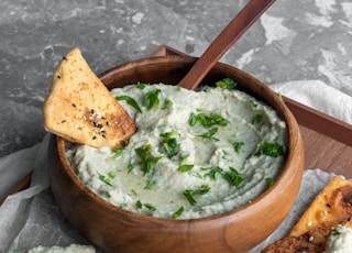 green soup on brown wooden bowl