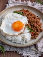 fried rice with sunny side up egg on gray ceramic plate