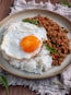 fried rice with sunny side up egg on gray ceramic plate