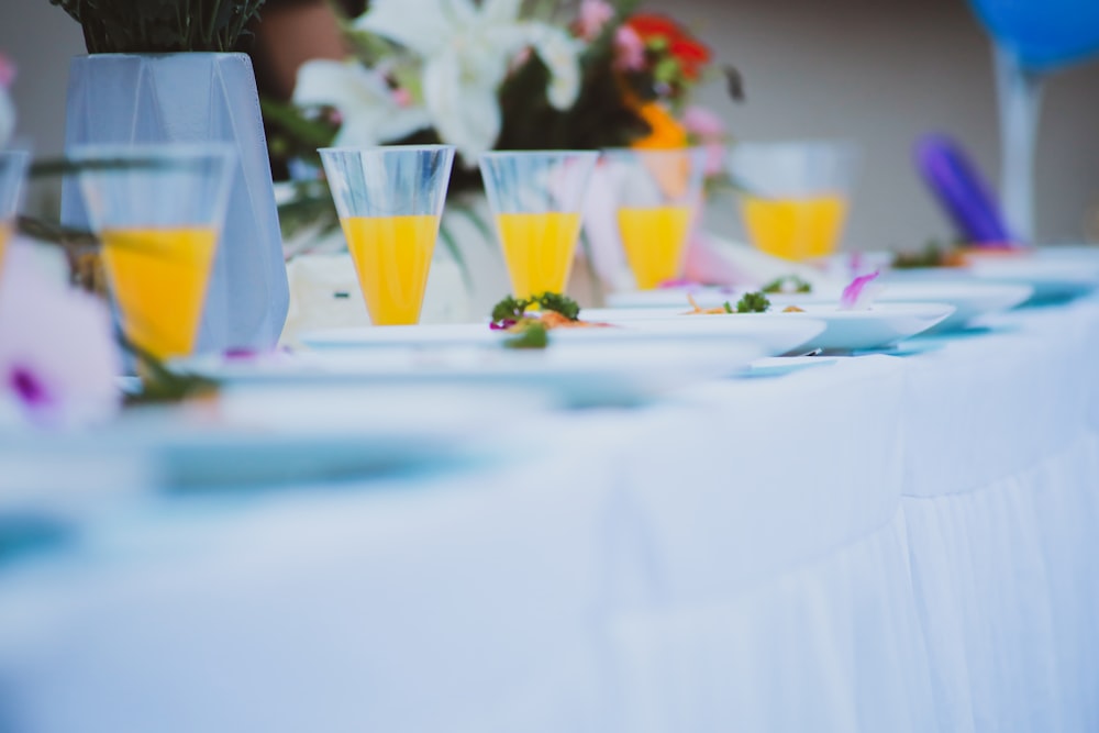 clear drinking glass on white table cloth