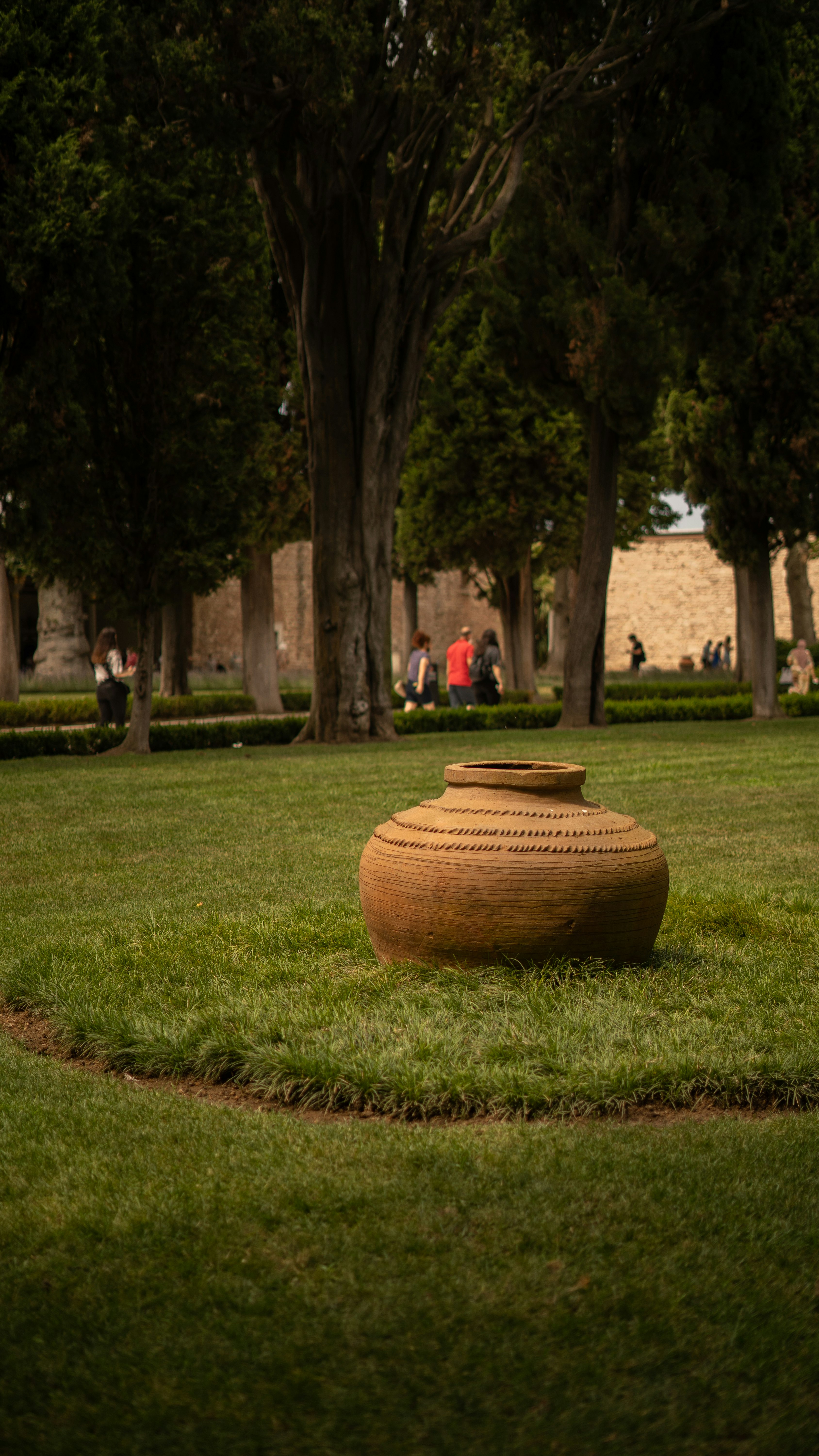 brown clay pot on green grass field