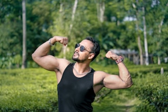 man in black tank top wearing black sunglasses