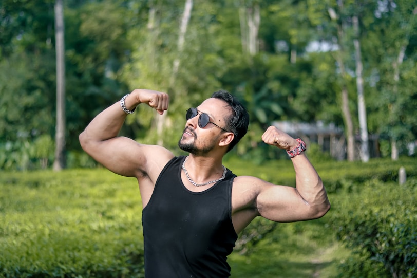 man in black tank top wearing black sunglasses