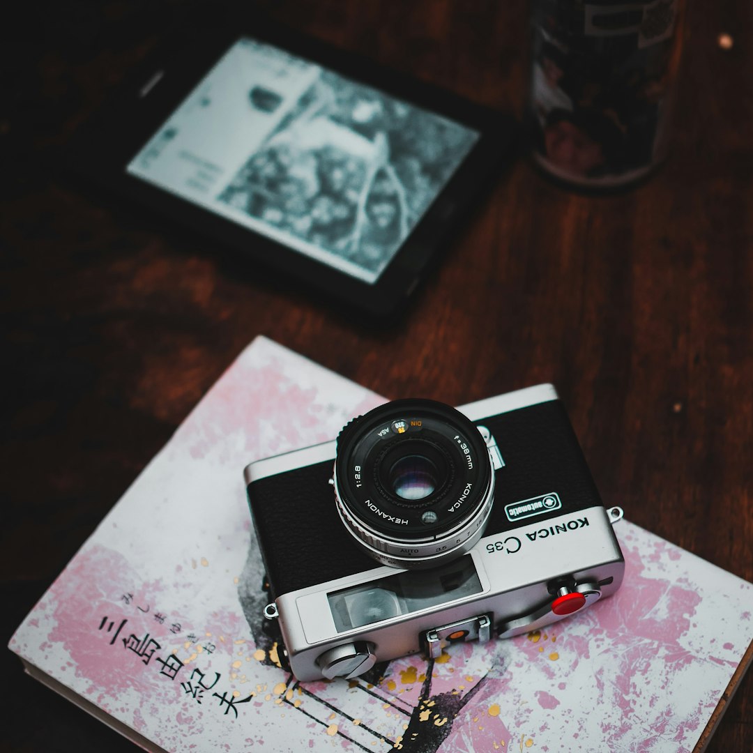 black and silver camera on brown wooden table