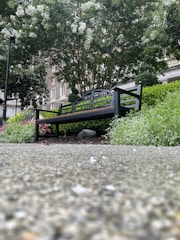 Photo showing a sturdy outdoor metal bench with a custom design in a garden setting.