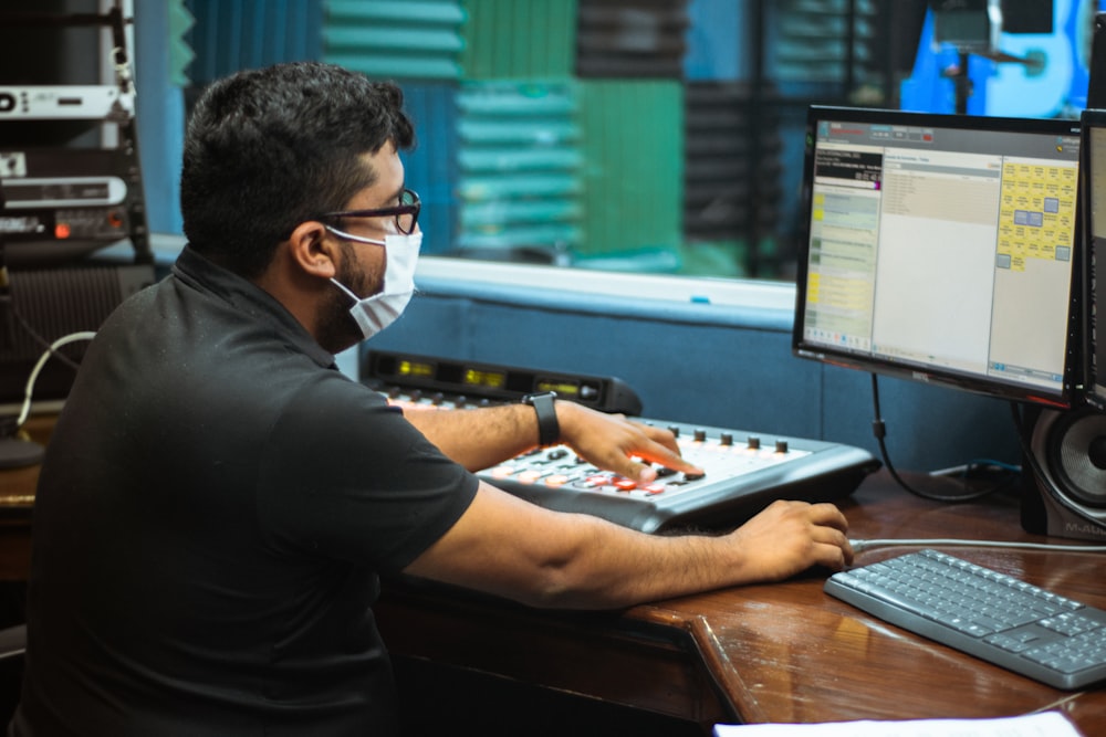 man in black long sleeve shirt using laptop computer