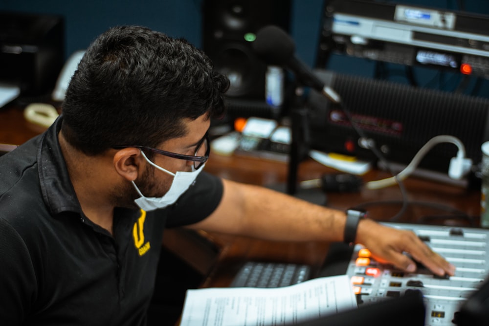 man in black and yellow polo shirt wearing white headphones