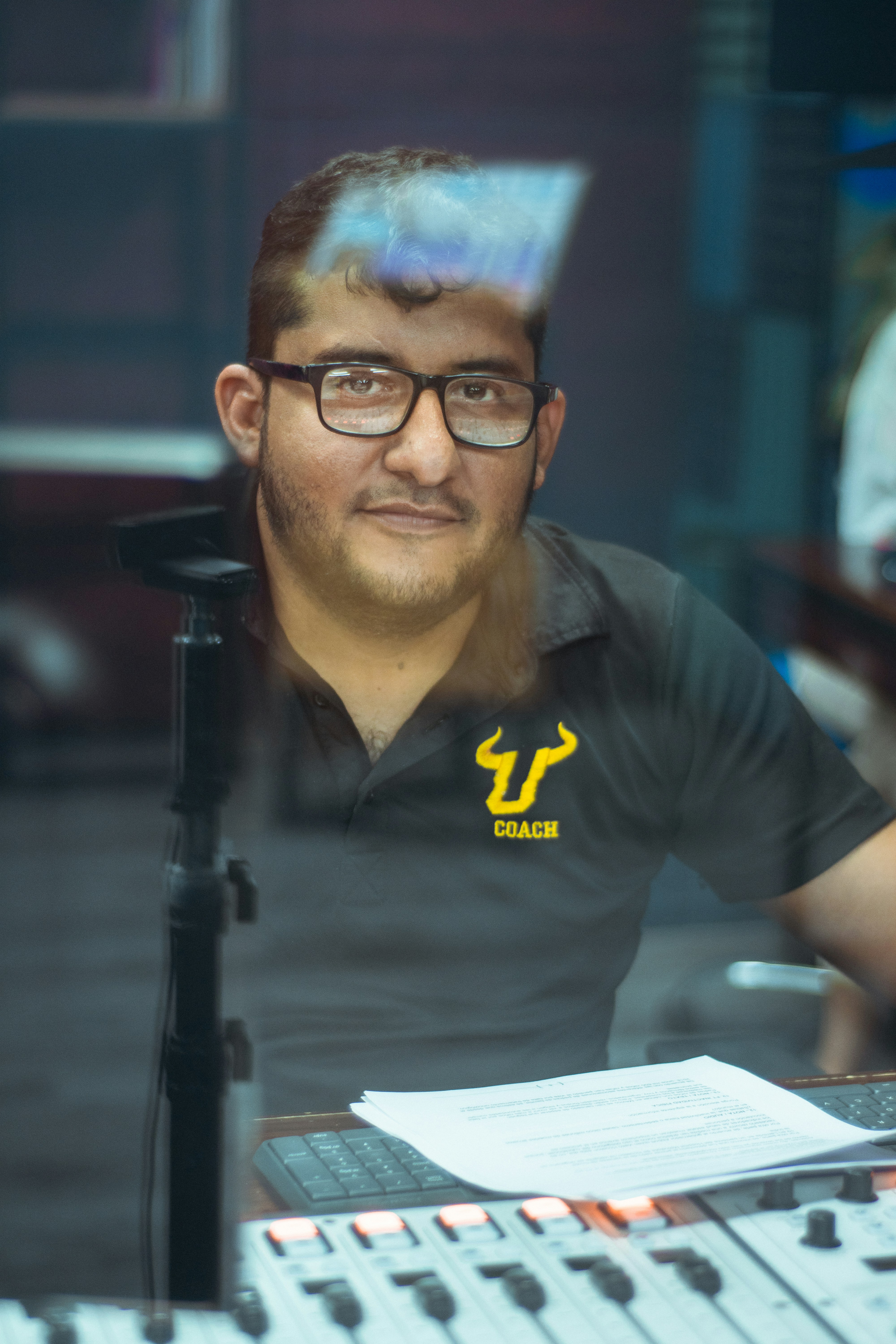 man in black polo shirt wearing eyeglasses