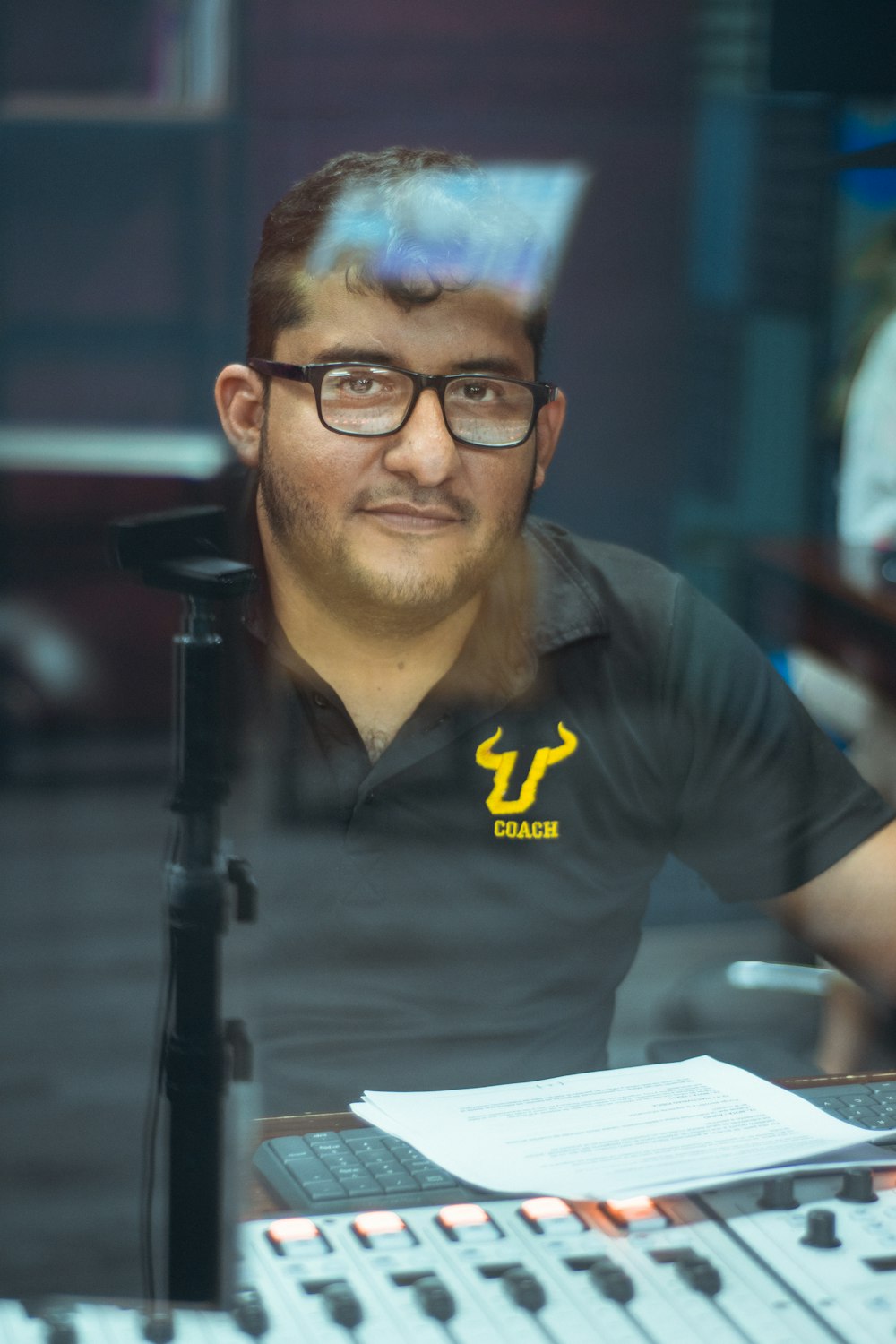 man in black polo shirt wearing eyeglasses