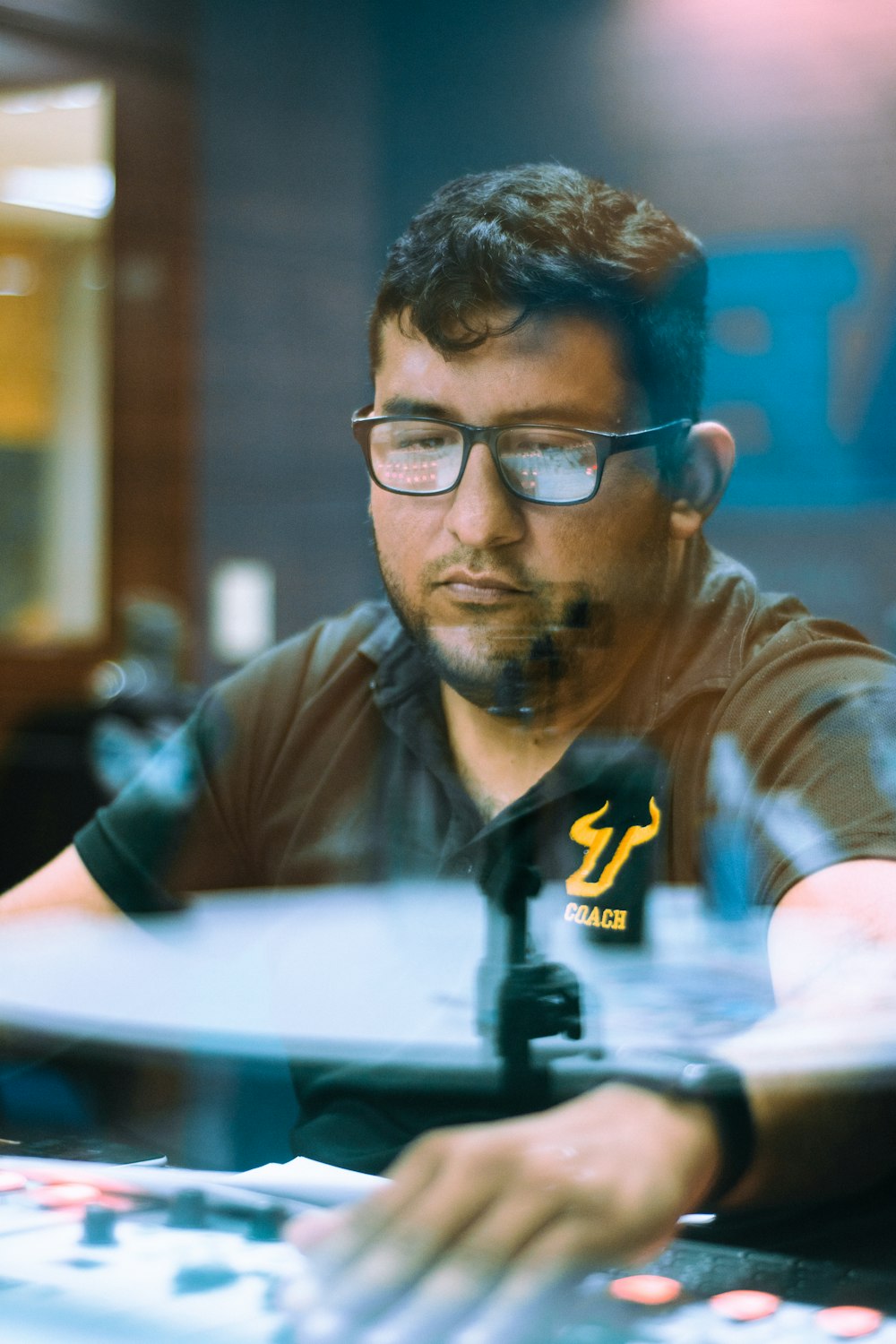 man in brown long sleeve shirt wearing black framed eyeglasses