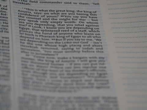 A close-up of a book page with printed text on it. The left side contains a passage from a book with a visible paragraph structure. On the right side, there is a section with lined space for notes. The text is dense and seems to be part of a narrative or dialogue.
