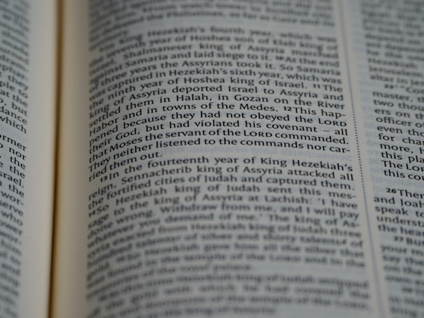 A close-up of an open book displaying printed text in English. The focus is on the center portion of the page, highlighting a passage with a mention of 'Moses' and 'LORD'. The text is formatted in two columns.
