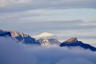 A misty morning view of a rugged mountain peak under soft sunlight.