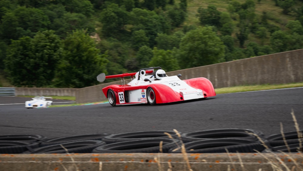 red and white racing car on track during daytime
