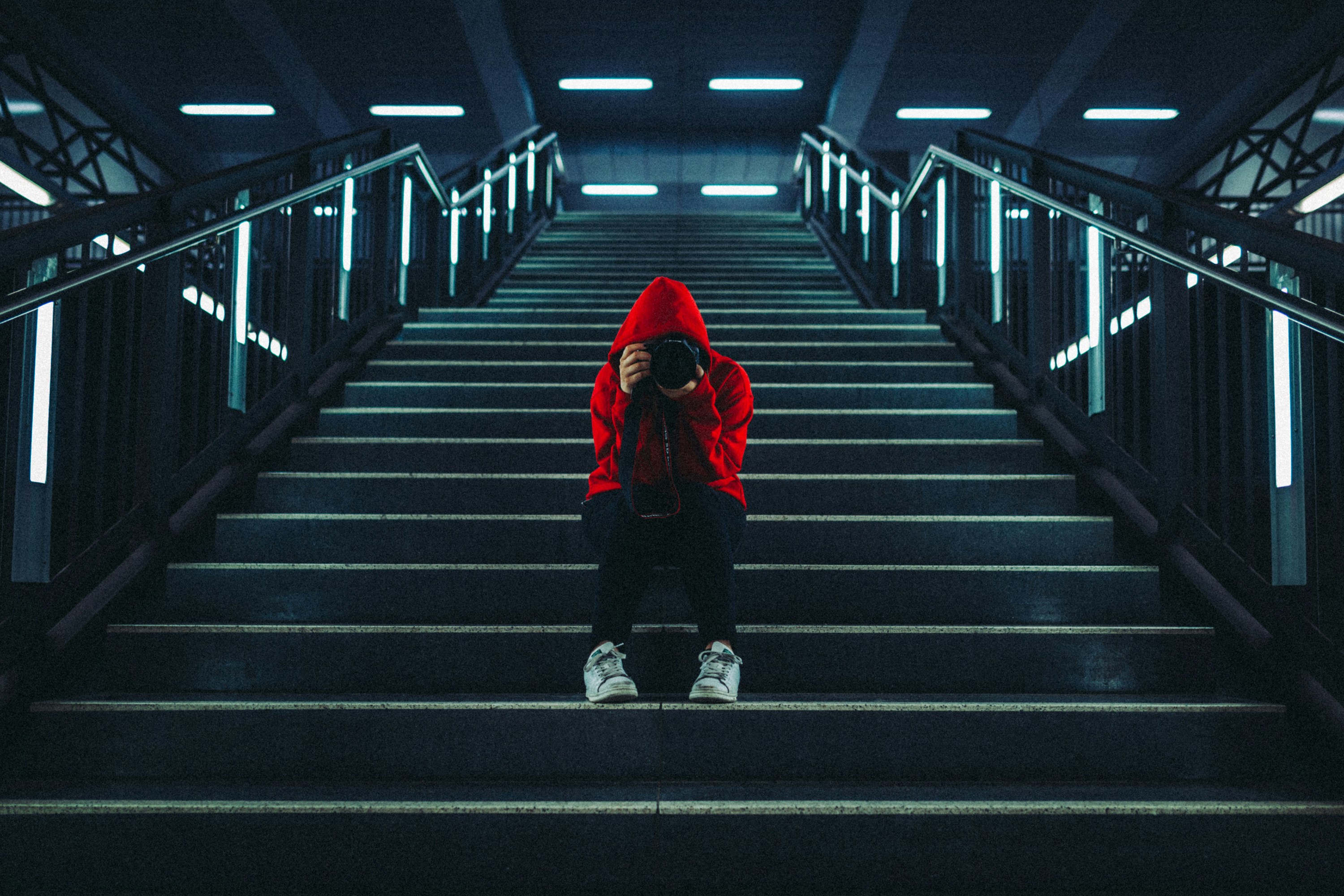 man in red jacket walking on the stairs