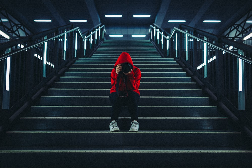 man in red jacket walking on the stairs