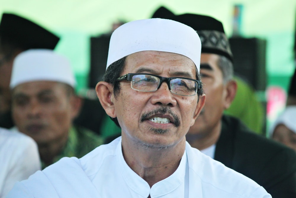 man in white dress shirt wearing black framed eyeglasses