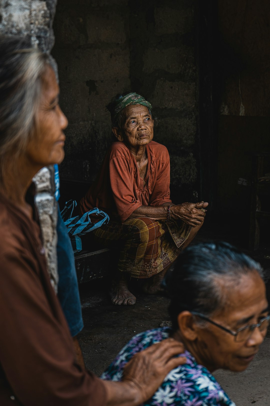 man in brown thobe sitting beside woman in brown and white dress