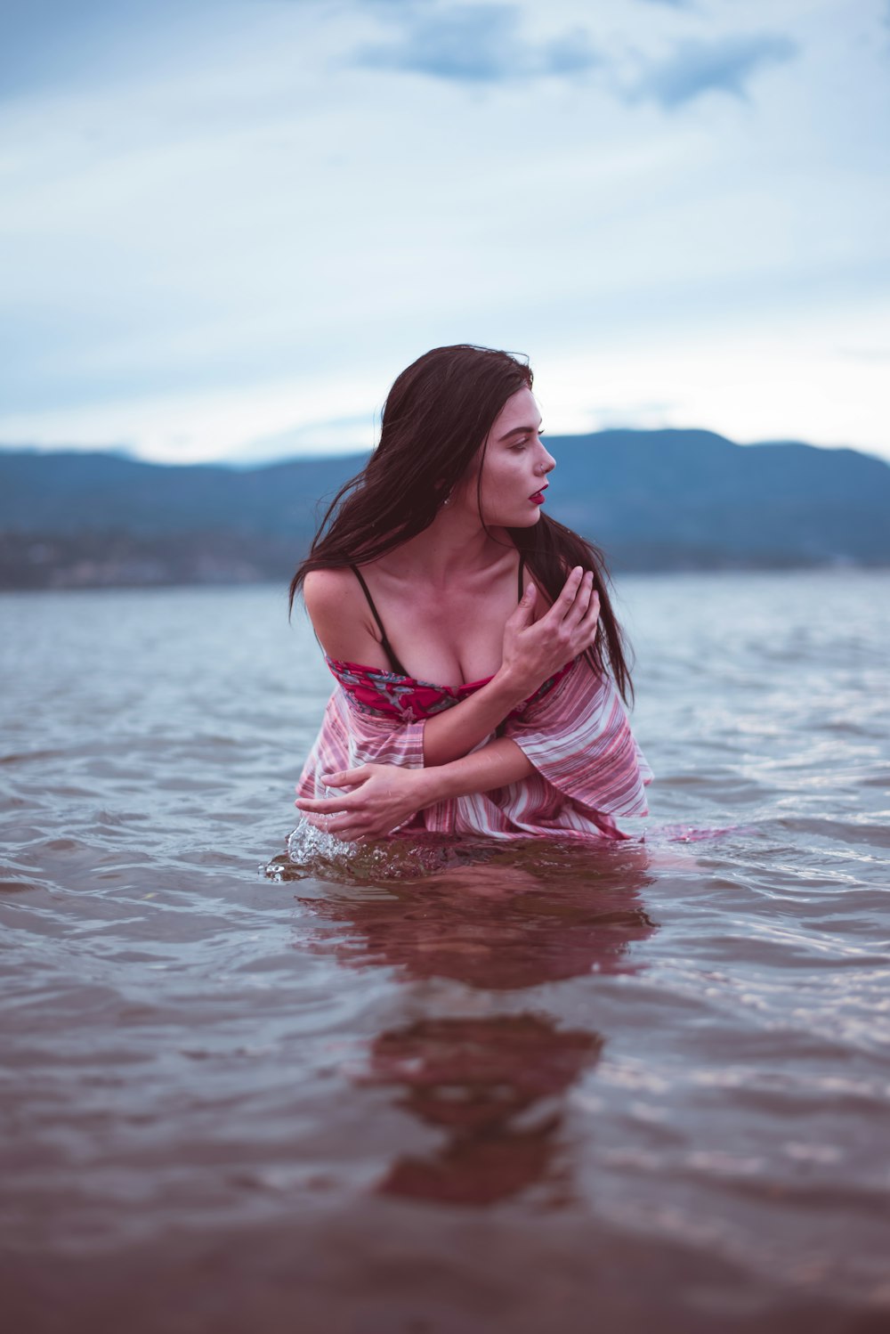 woman in pink dress on water during daytime