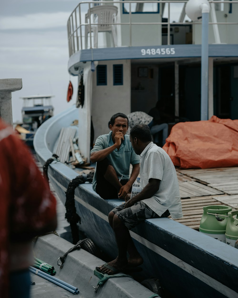 man in gray t-shirt sitting on boat during daytime