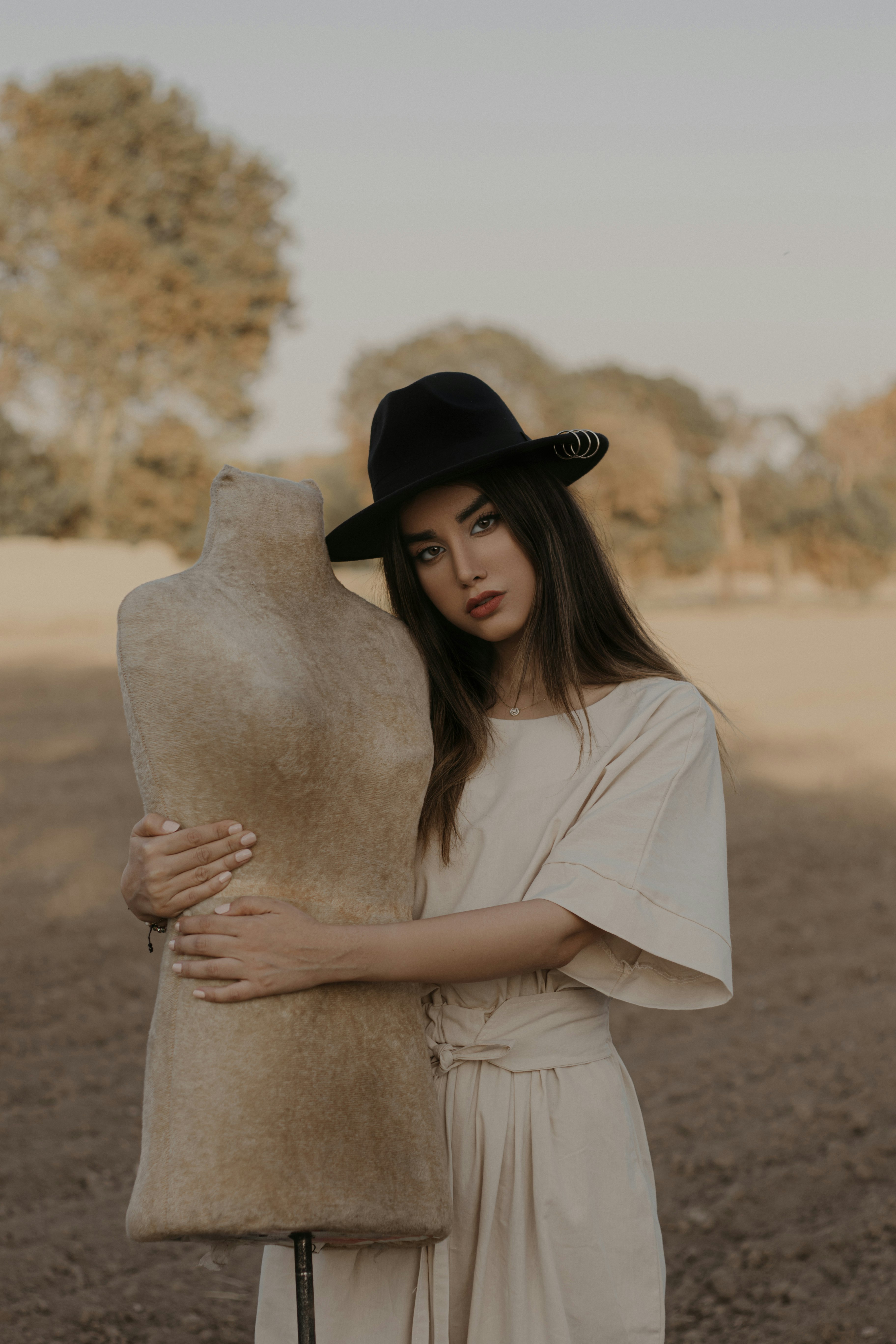 woman in white shirt wearing black fedora hat